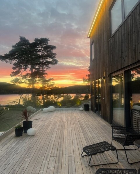 Denna moderna tappning på den klassiska fjällstugan beställdes av kund som ett fritidsboenden på en av Sveriges populära skidorter.
Huset är utvändigt klätt med svart panel och invändigt med en mörkbrun murrig panel. Den höga fönsterbeklädda gaveln vetter ut mot skidbacken och ger en vacker vidsträckt utsikt över landskapet från både allrummet och från loftets balkong. Den centrerade kaminen förstärker rummets höjd när det leder ögat upp.